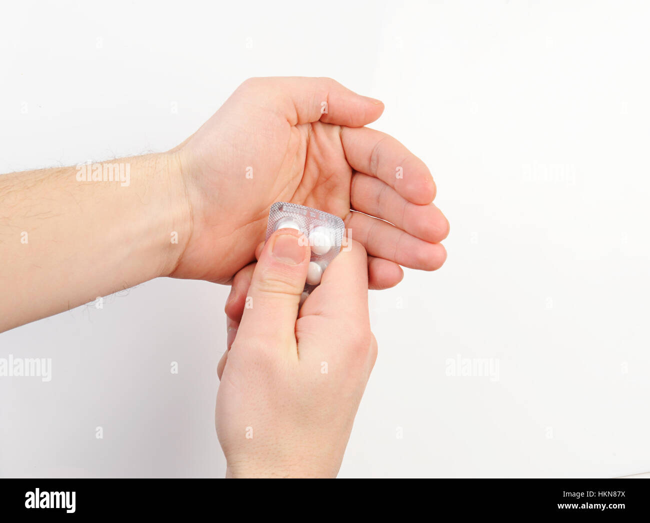 Pack of pill in hand on white background Stock Photo