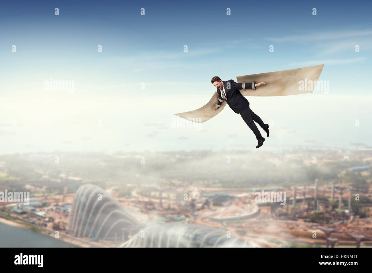 Young businessman with paper wings flying in sky Stock Photo - Alamy