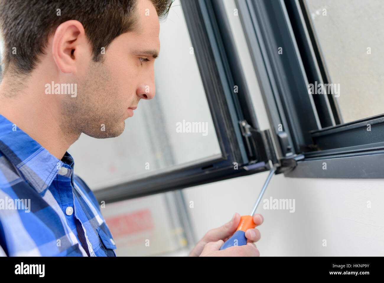 man fixing window Stock Photo - Alamy
