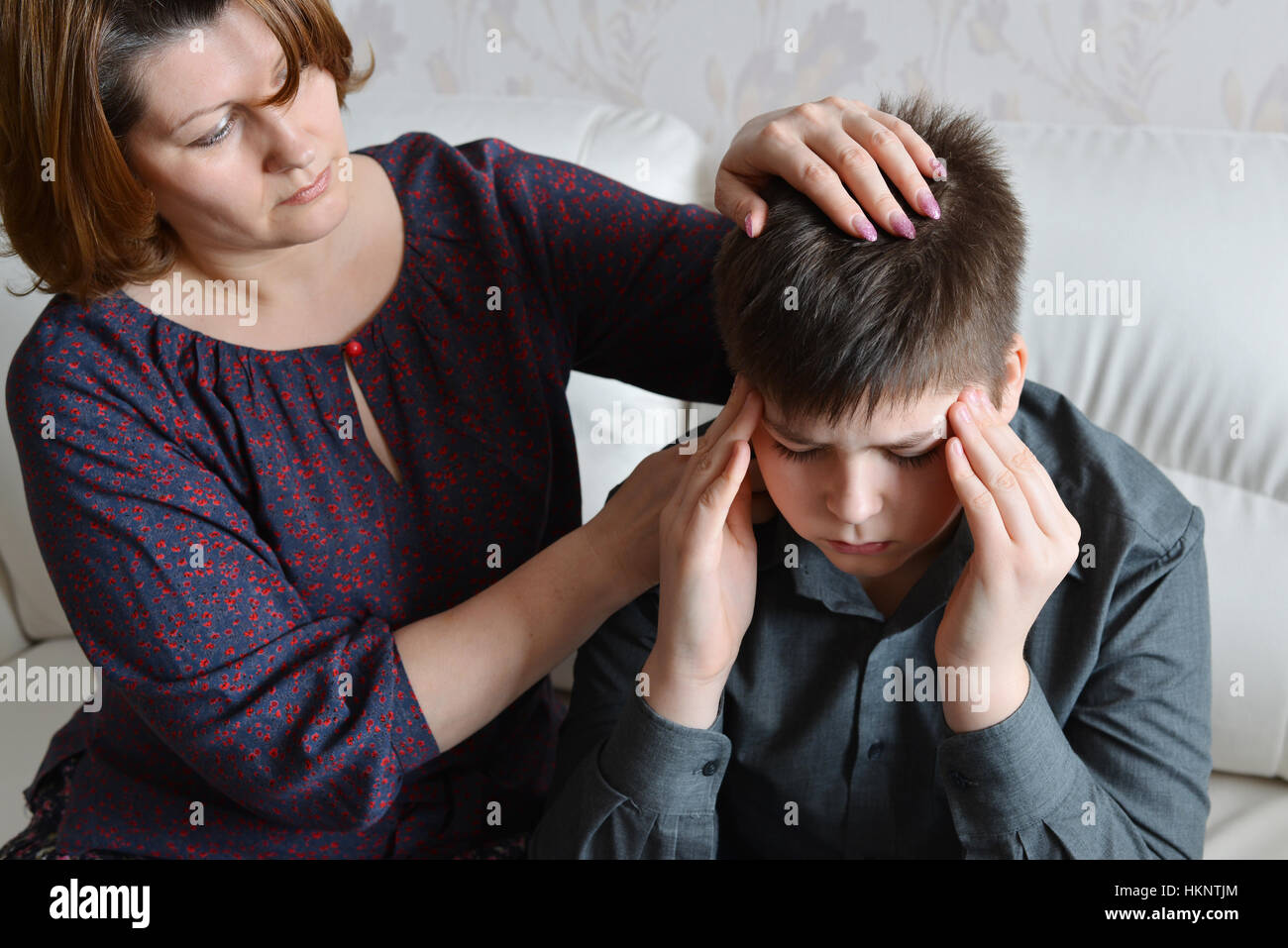 mother cares for her son who has headache Stock Photo