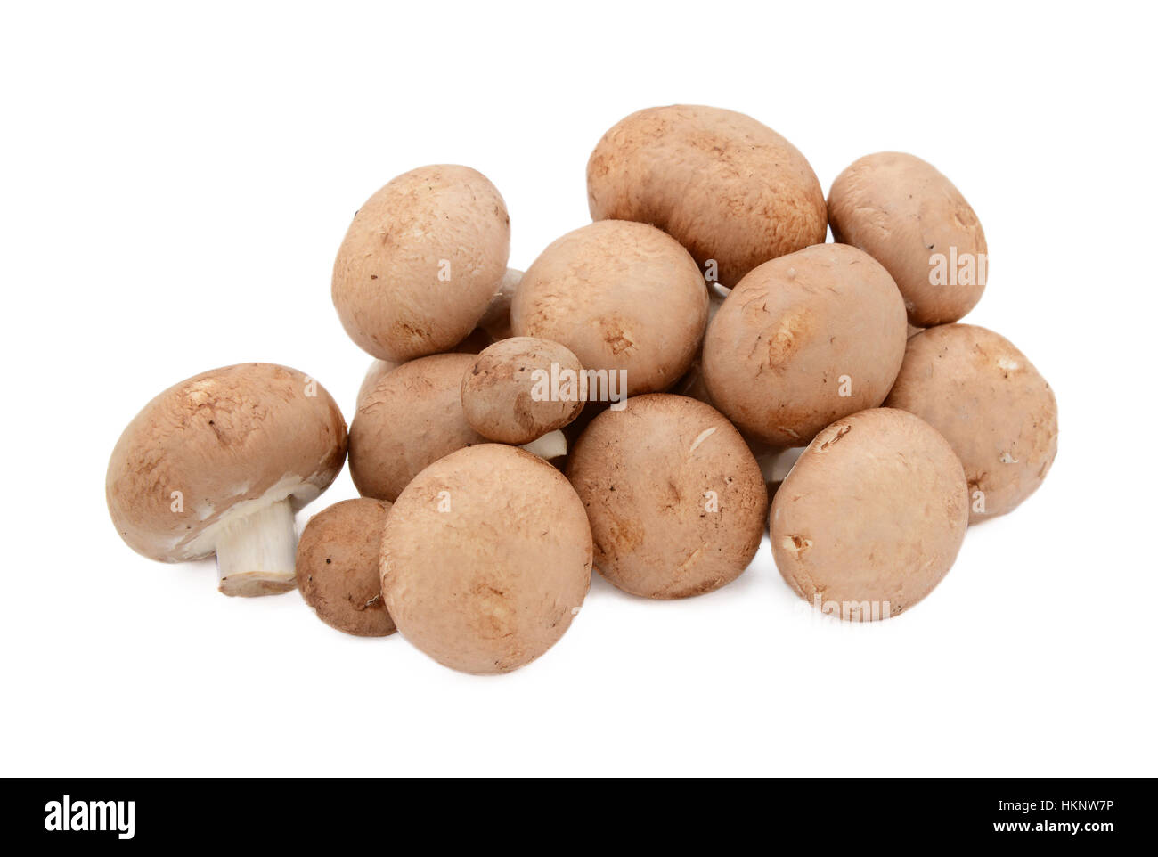 Uneven pile of fresh chestnut mushrooms with brown caps, isolated on a white background Stock Photo