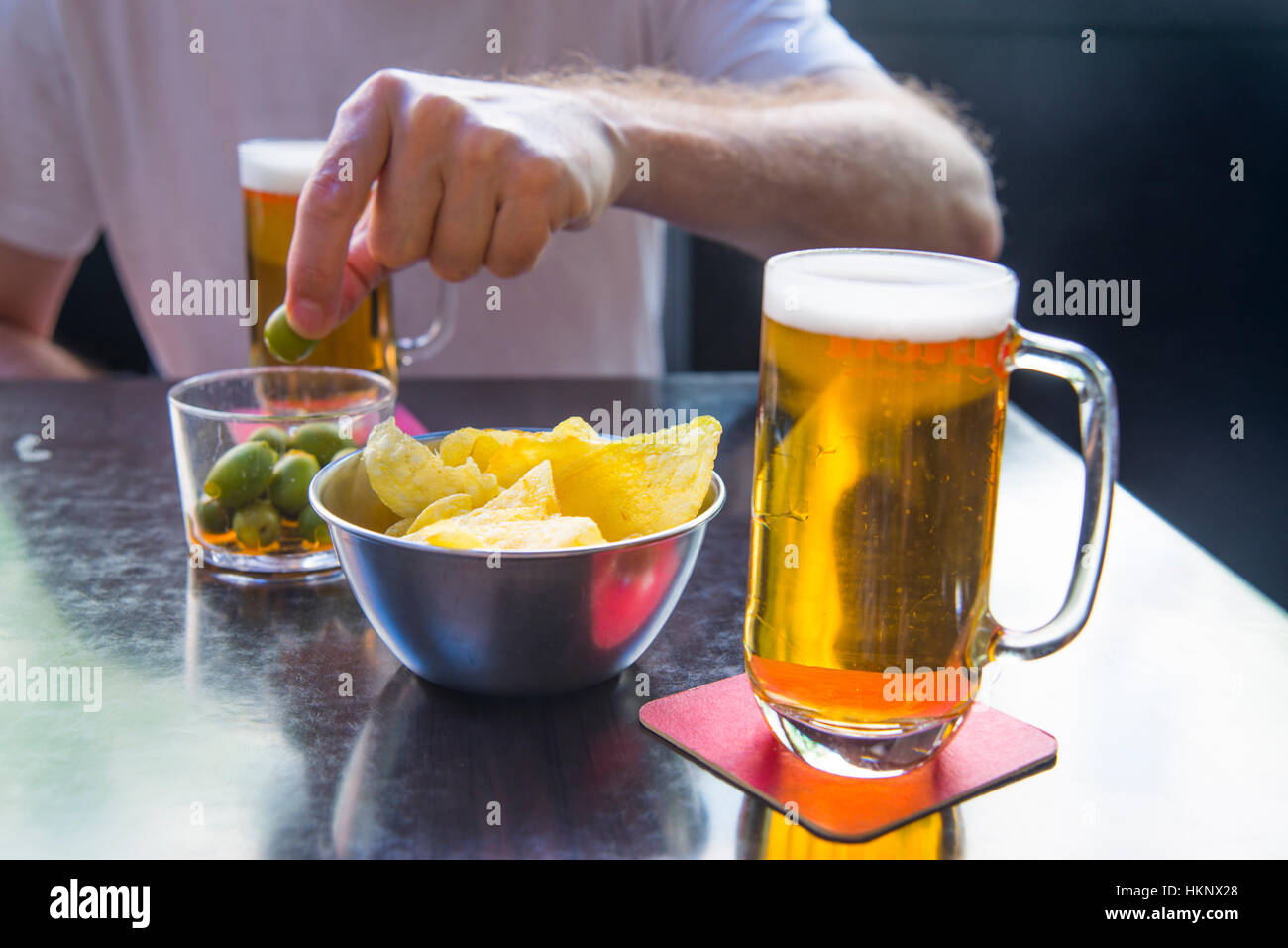 Two glasses of beer and green olives in a terrace. Spain. Stock Photo