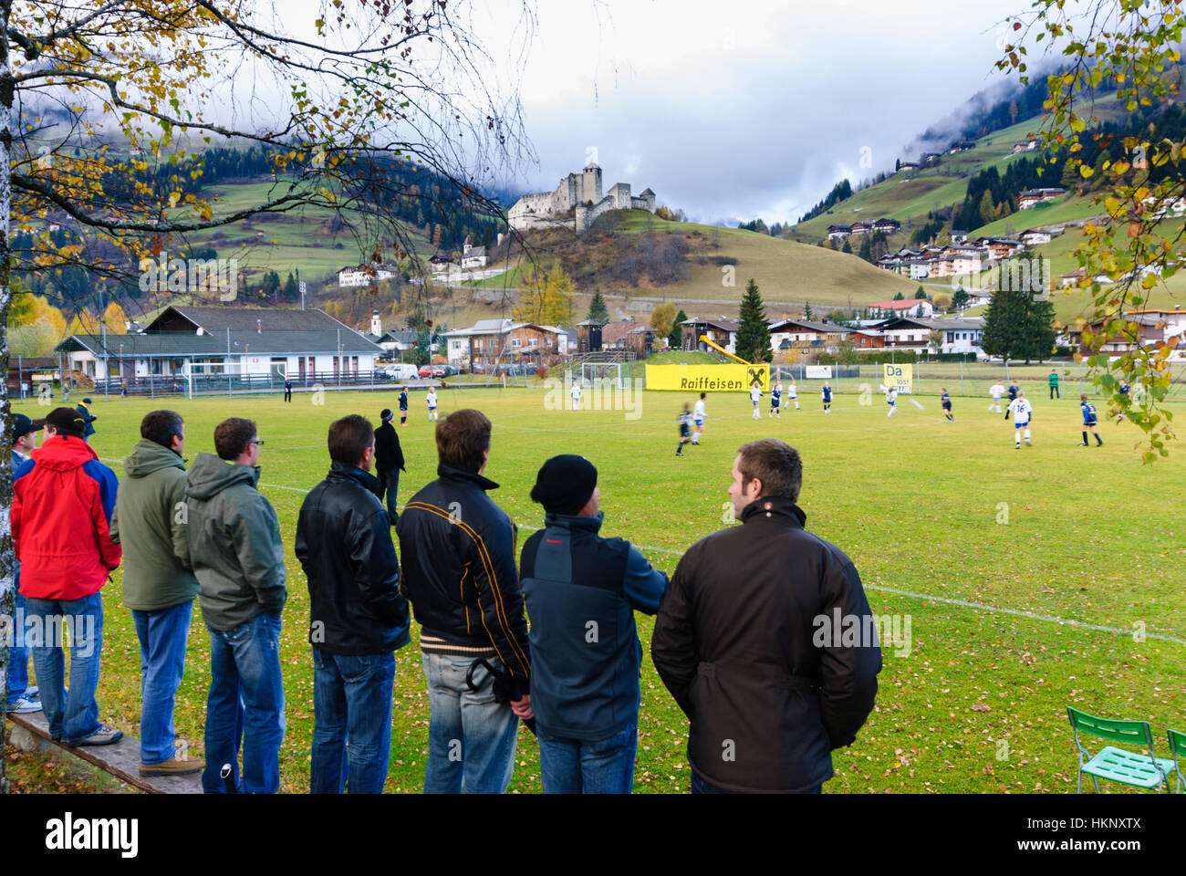 Heinfels-Panzendorf: Fathers watch the football game of their sons in front of Schloss Heinfels, Osttirol, East Tyrol, Tirol, Tyrol, Austria Stock Photo