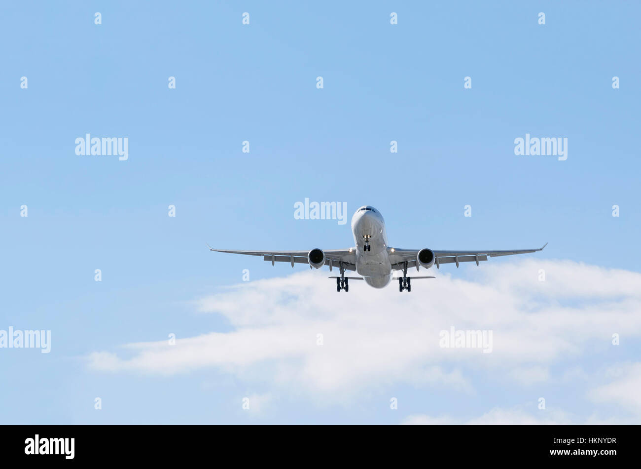 Airplane Airbus A330, of Iberia airline. Blue sky with some clouds. Stock Photo