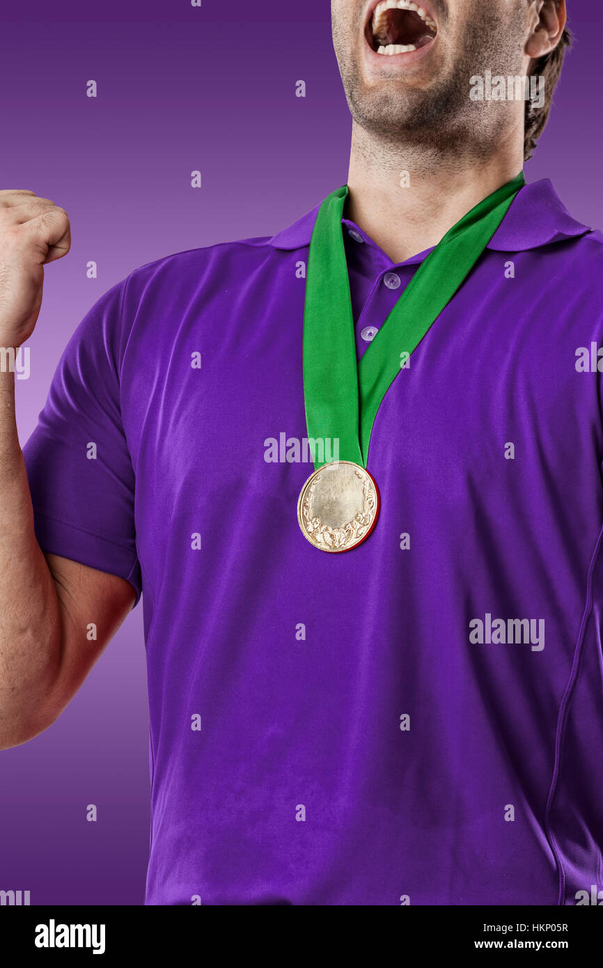 Golf Player in a purple shirt celebrating with a golden medal, on a ...