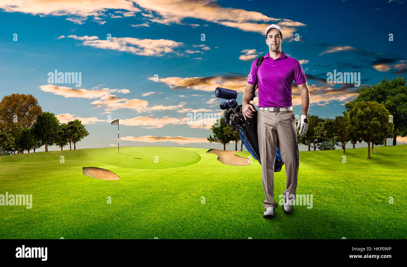 Golf Player in a pink shirt walking with a bag of golf clubs on his