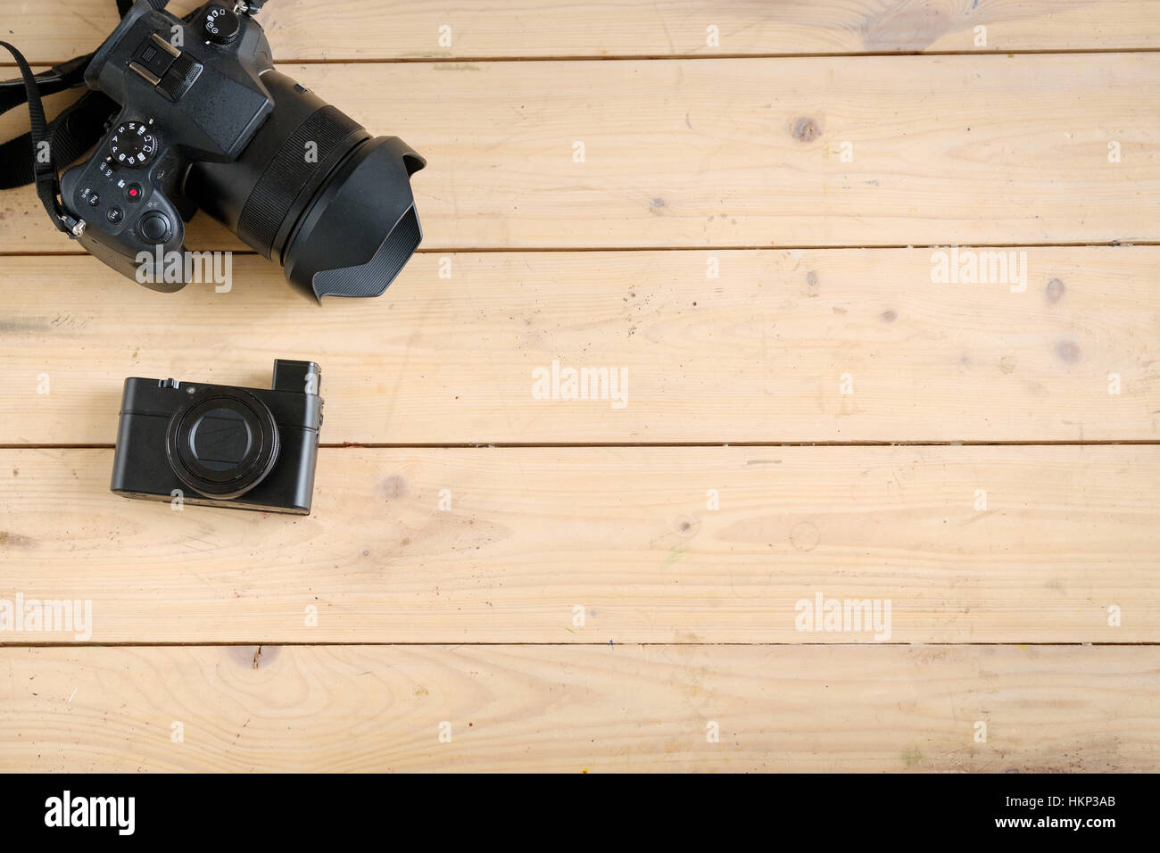 Digital cameras on the wooden table Stock Photo Alamy