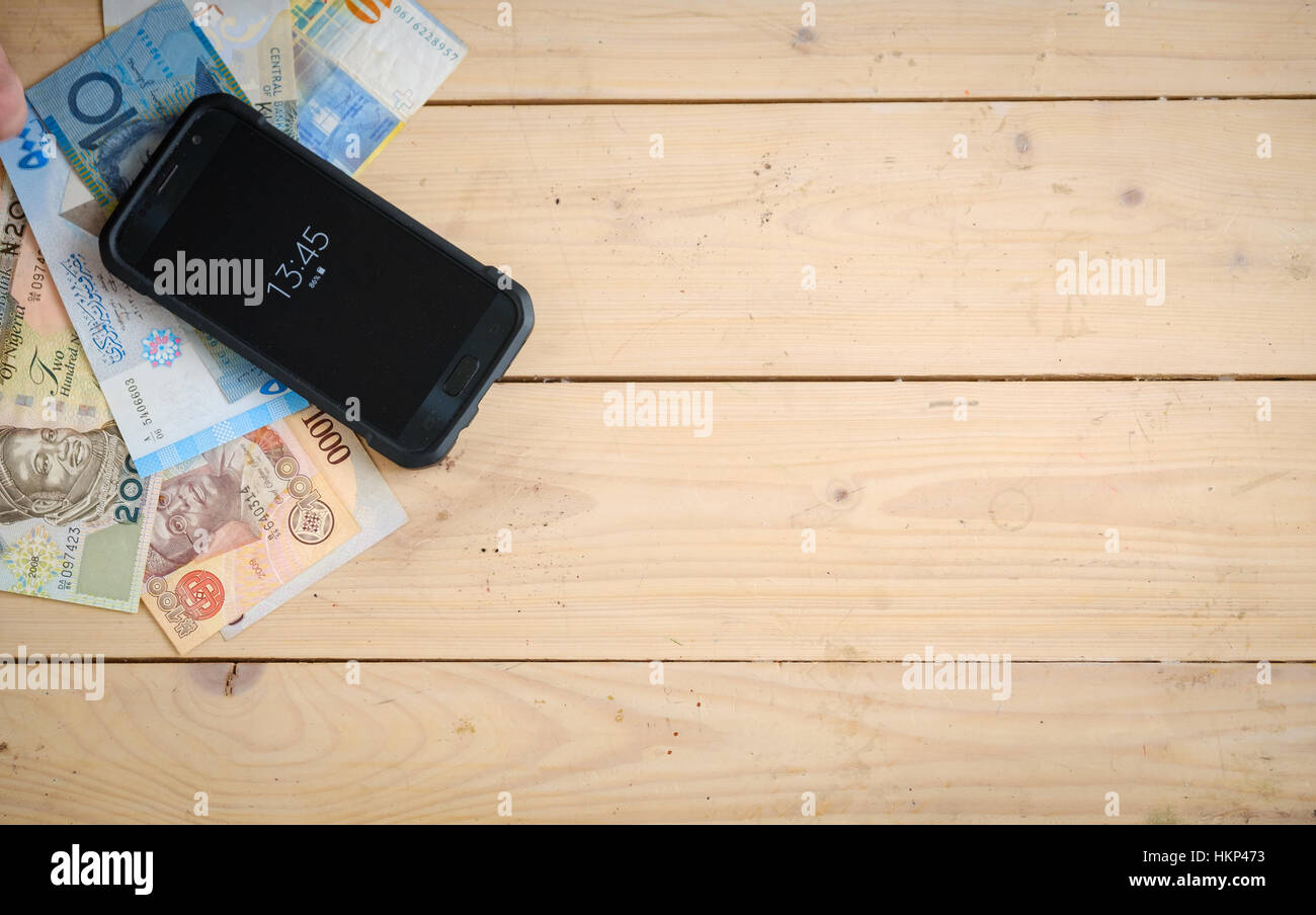 Banknotes different countries on the wooden table Stock Photo - Alamy