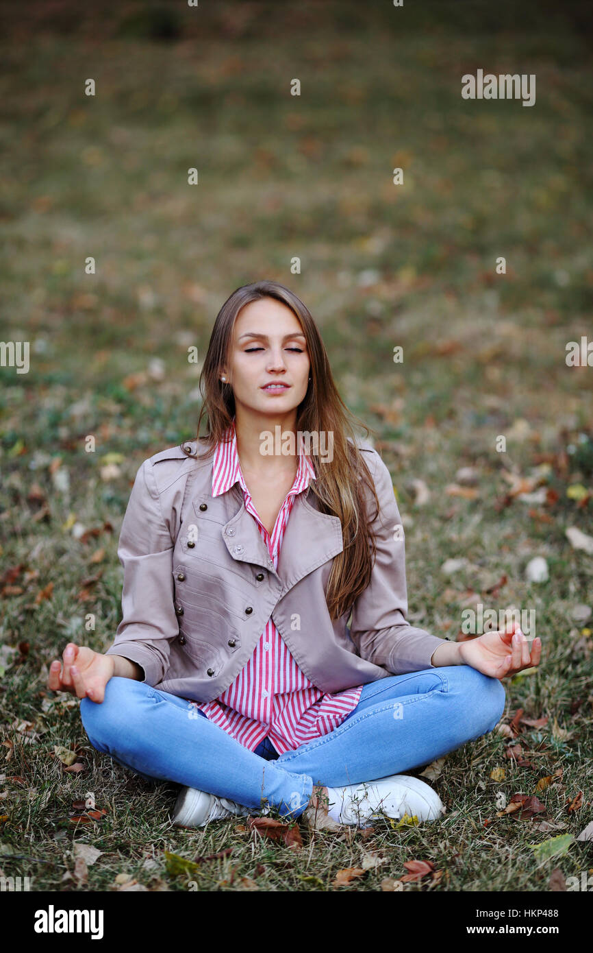 Young beautiful woman sitting with closed eyes Stock Photo - Alamy