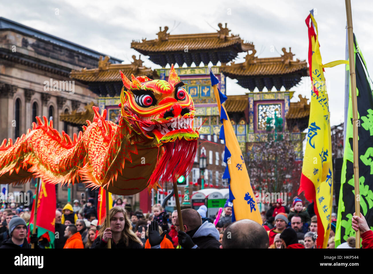 Close-up of orange and red coloured dragon in Liverpool's Chinatown chasing a pearl during Chinese New Year celebrations Stock Photo