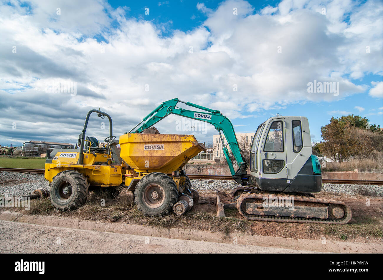 Dump truck and backhoe for civil work, near the city Stock Photo