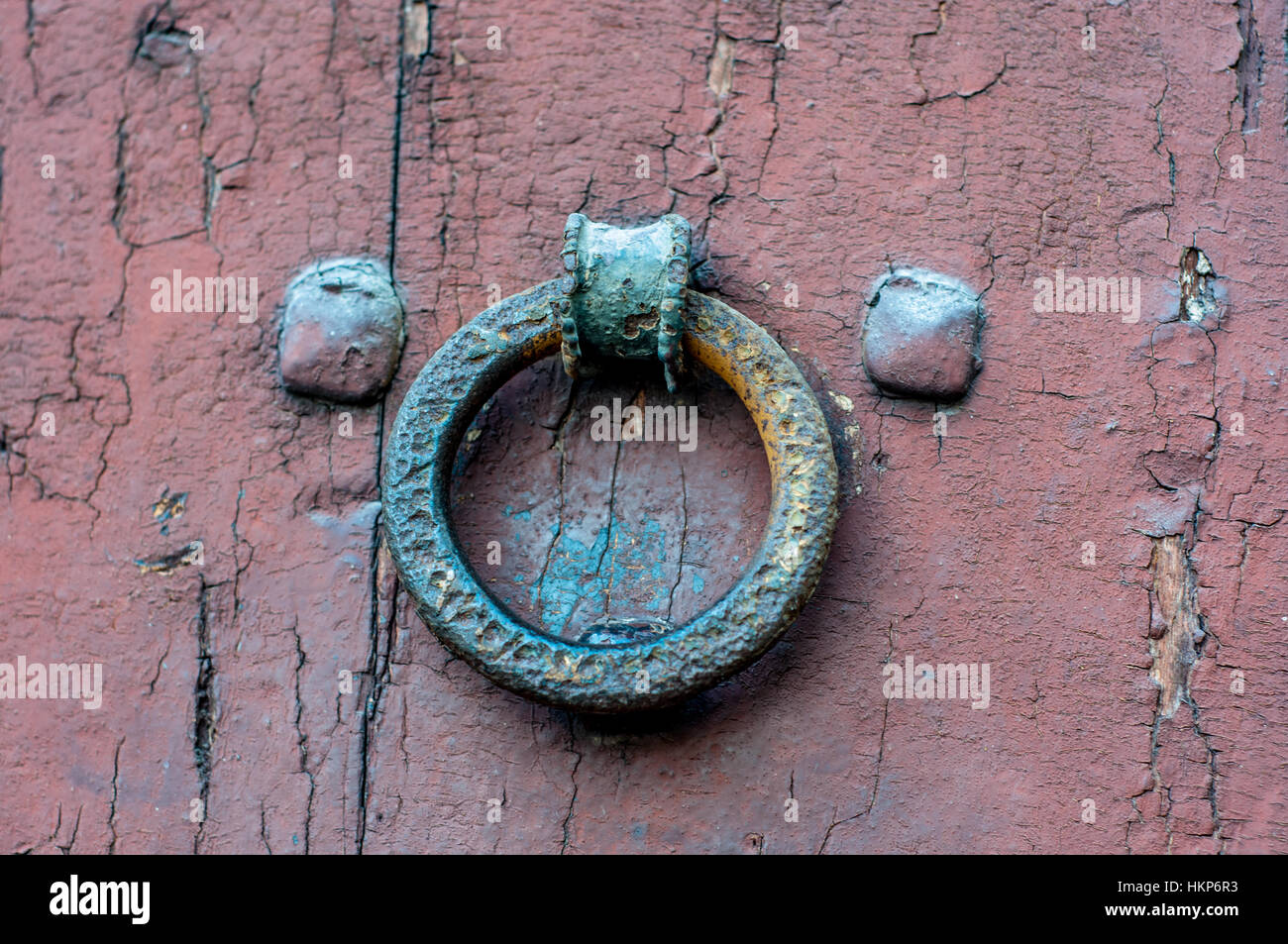 Wrought iron door knob, wooden door Stock Photo