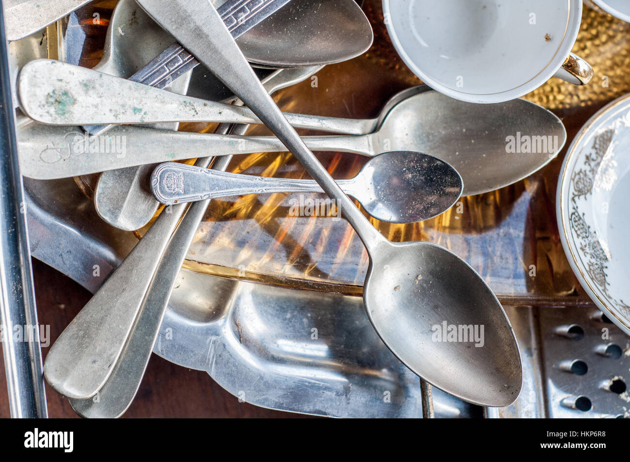 Old second-hand crockery, cutlery to sell on the street Stock Photo