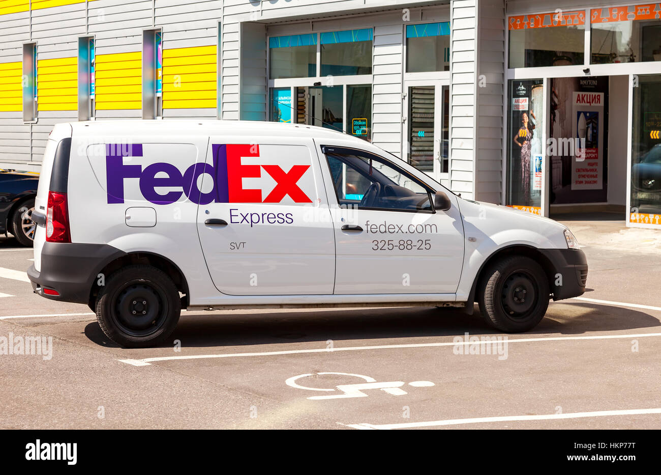 SAINT PETERSBURG, RUSSIA - JULY 28, 2016: FedEx delivery car parked up on the city street in summer sunny day Stock Photo