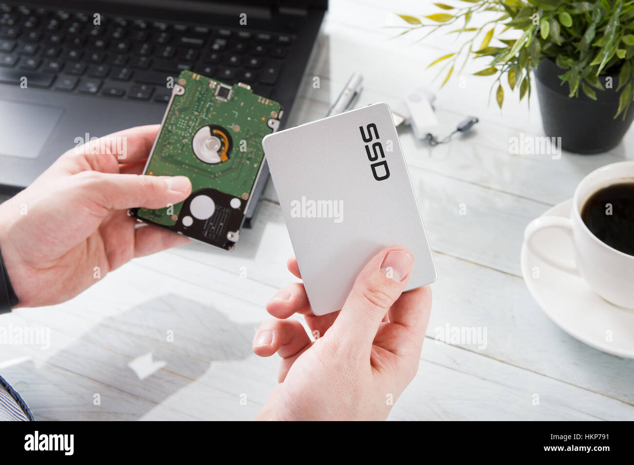 Man changes hard drive disk to a modern ssd Stock Photo