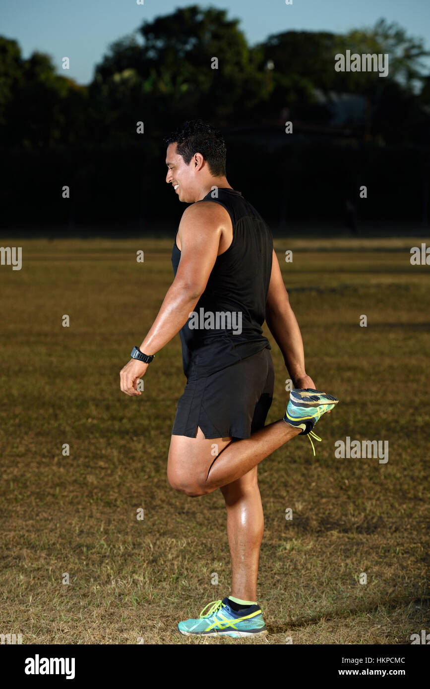 sport man stretching feet outdoor on grass park Stock Photo Alamy