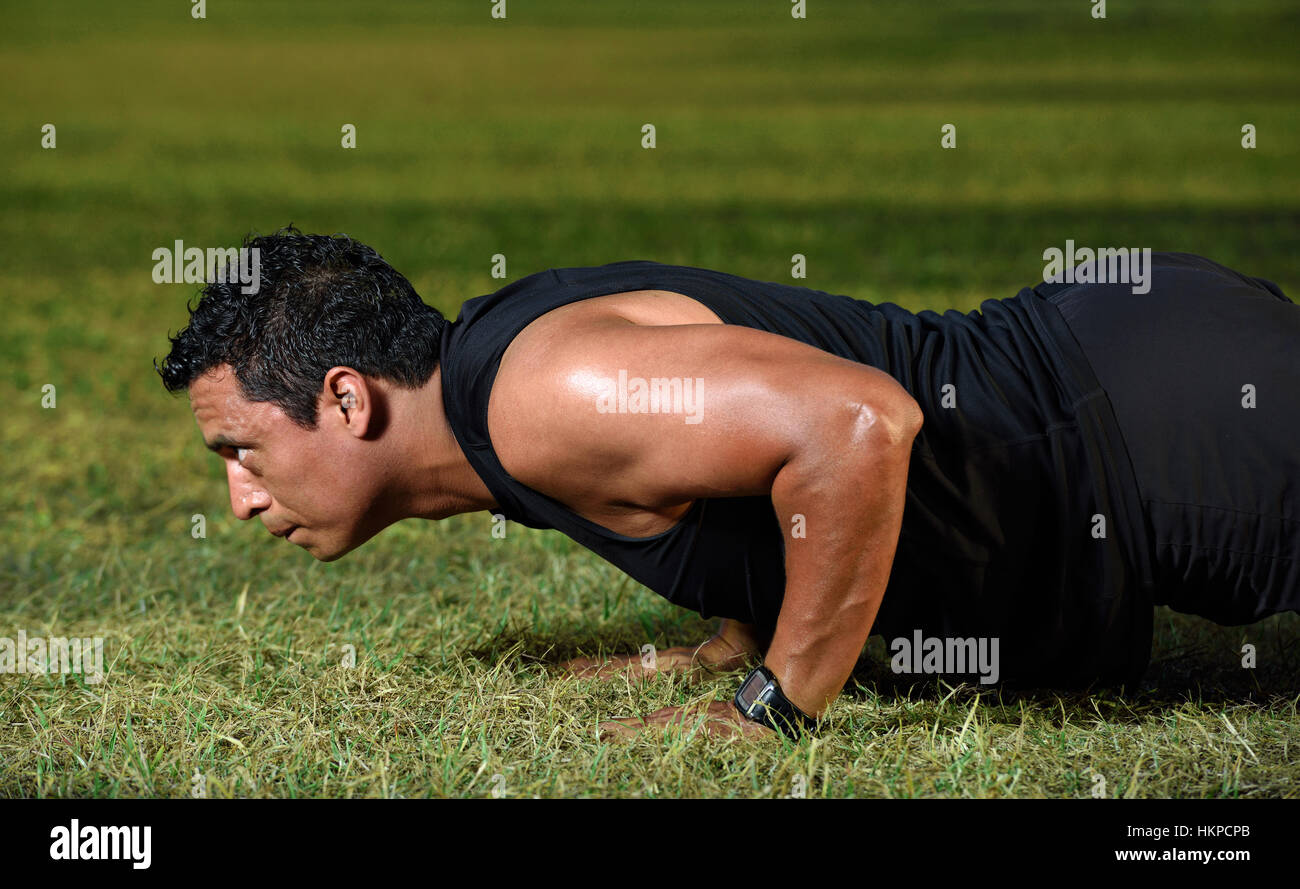 close up of working out man doing push up on green grass Stock Photo ...