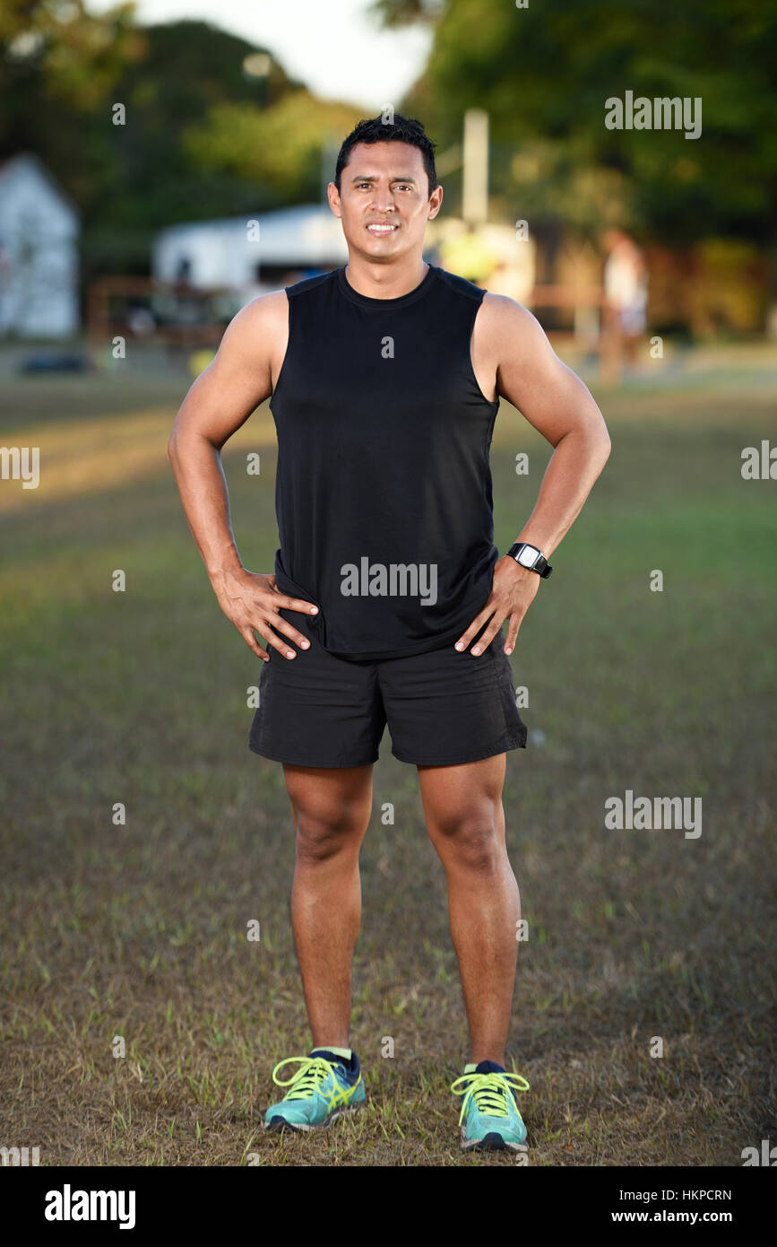 sport man with hands on hips on park grass Stock Photo Alamy