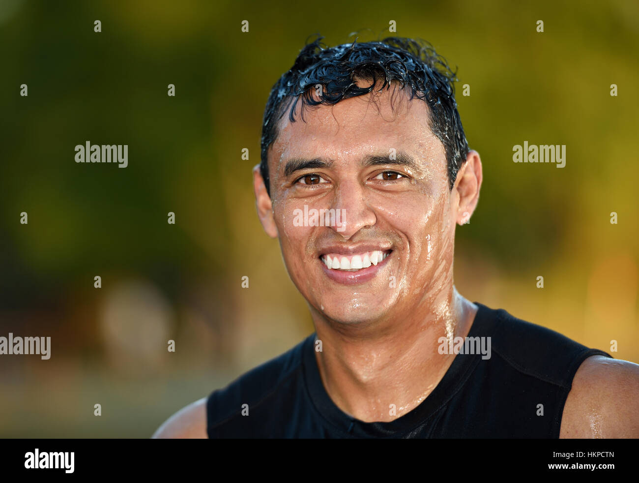 close up of wet fresh man face on blurred background Stock Photo