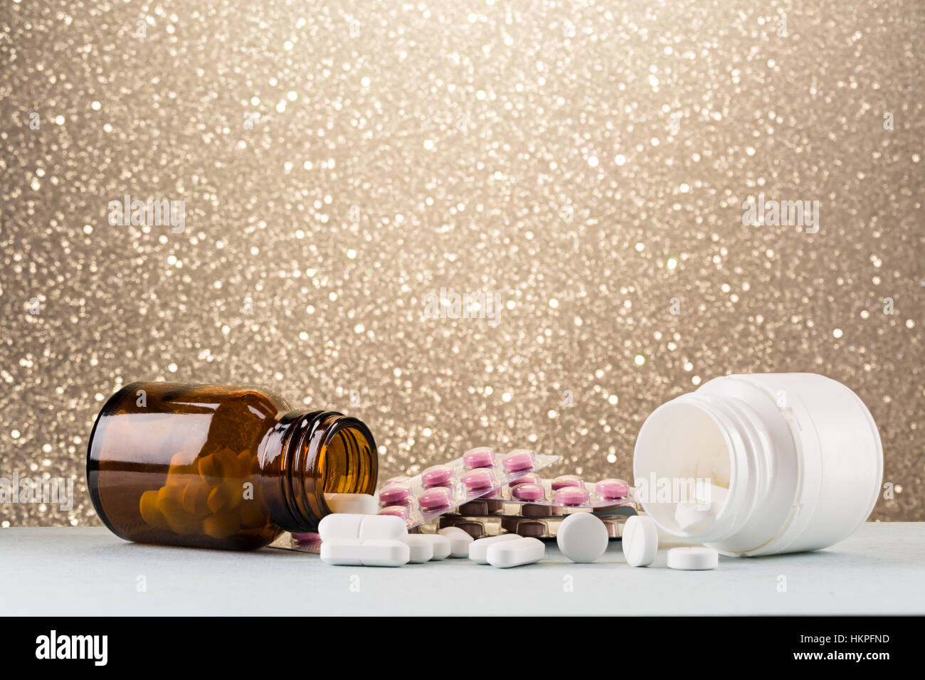 Various pill bottle and heap of white pills Stock Photo