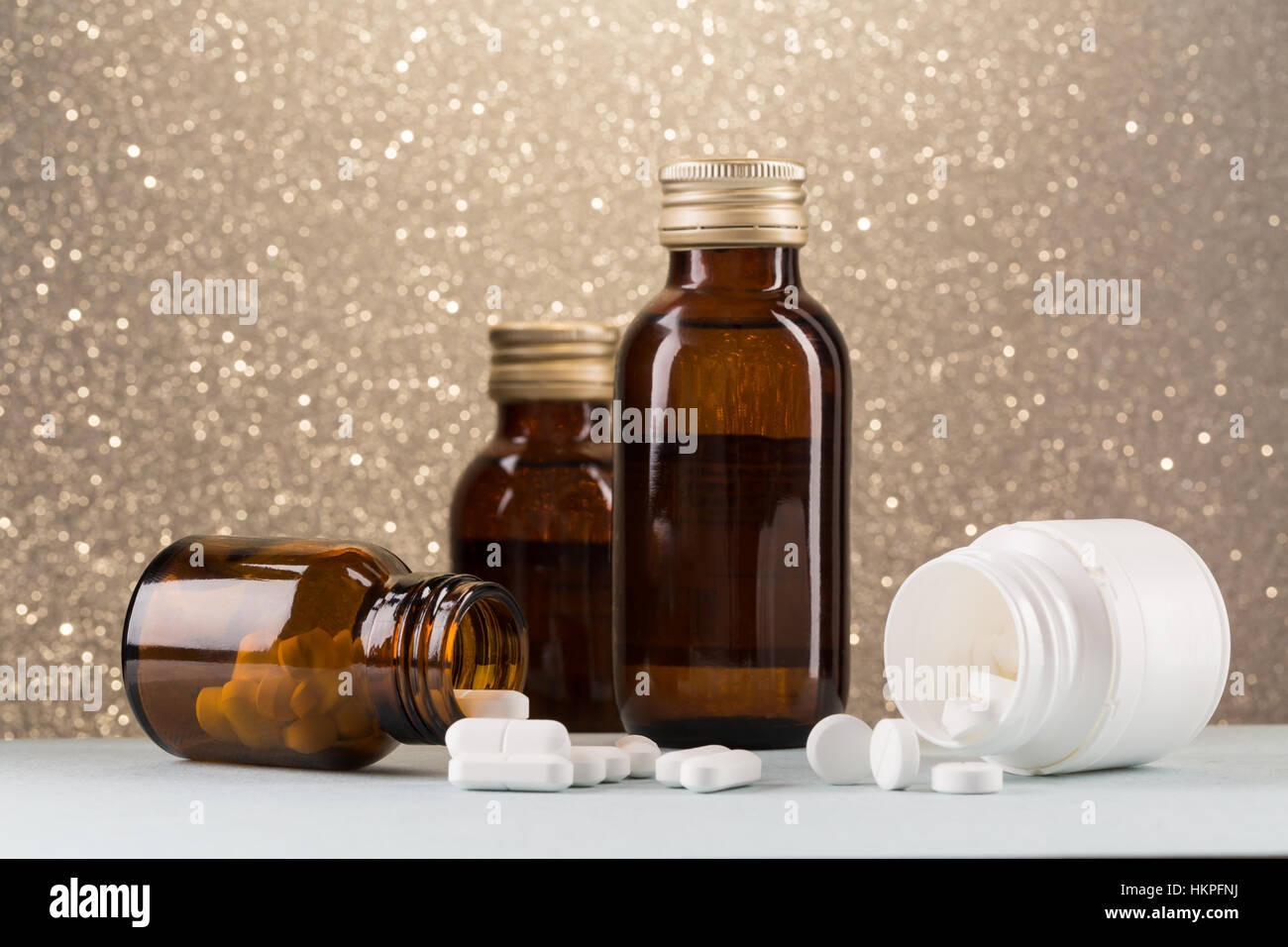 Various pill bottles and white pills Stock Photo
