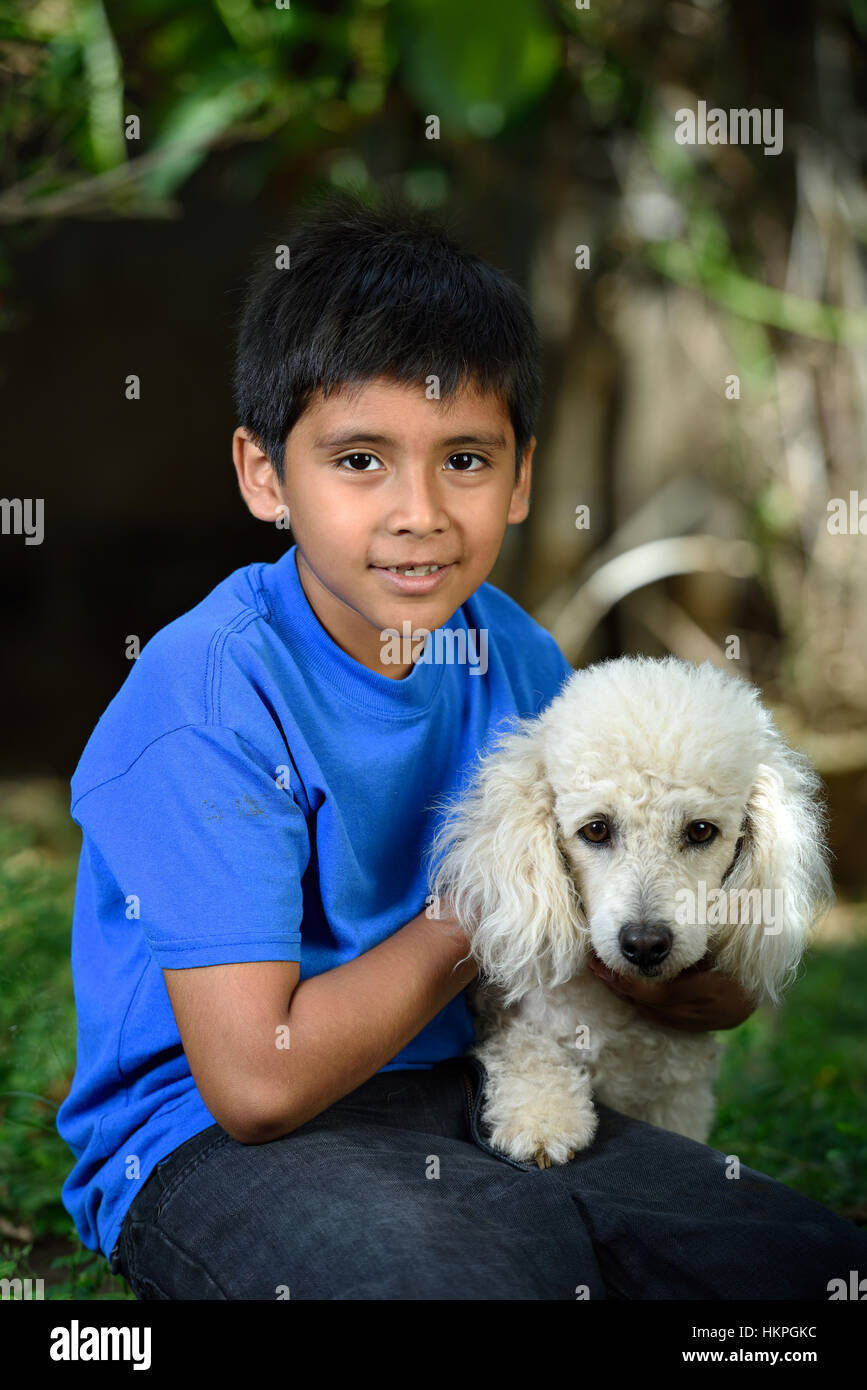 little boy with white poodlein green park Stock Photo