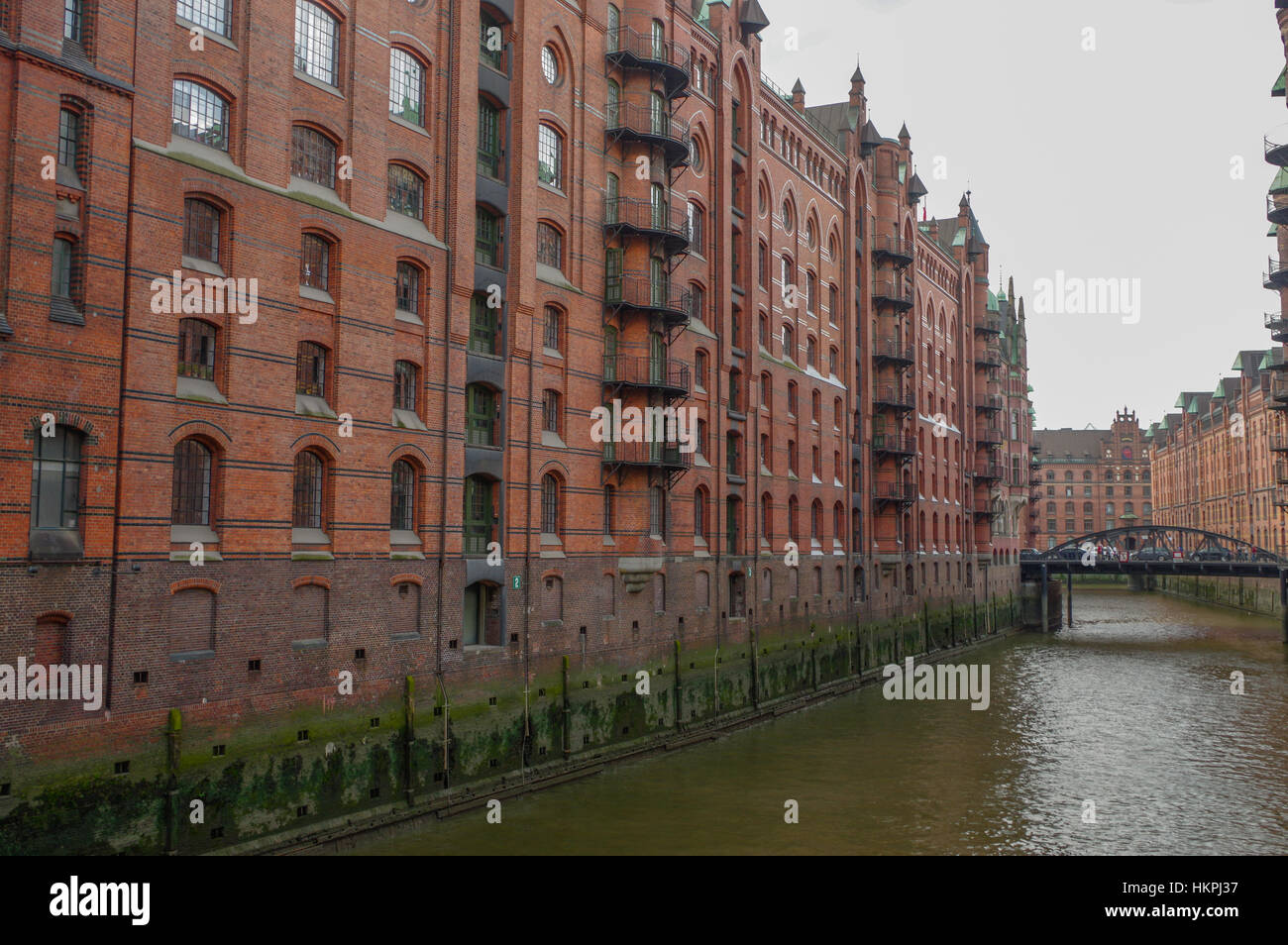 HAMBURG, GERMANY - JULY 18, 2015: canal of Historic Speicherstadt houses and bridges at evening with amaising skyview over warehouses, famous place on Stock Photo