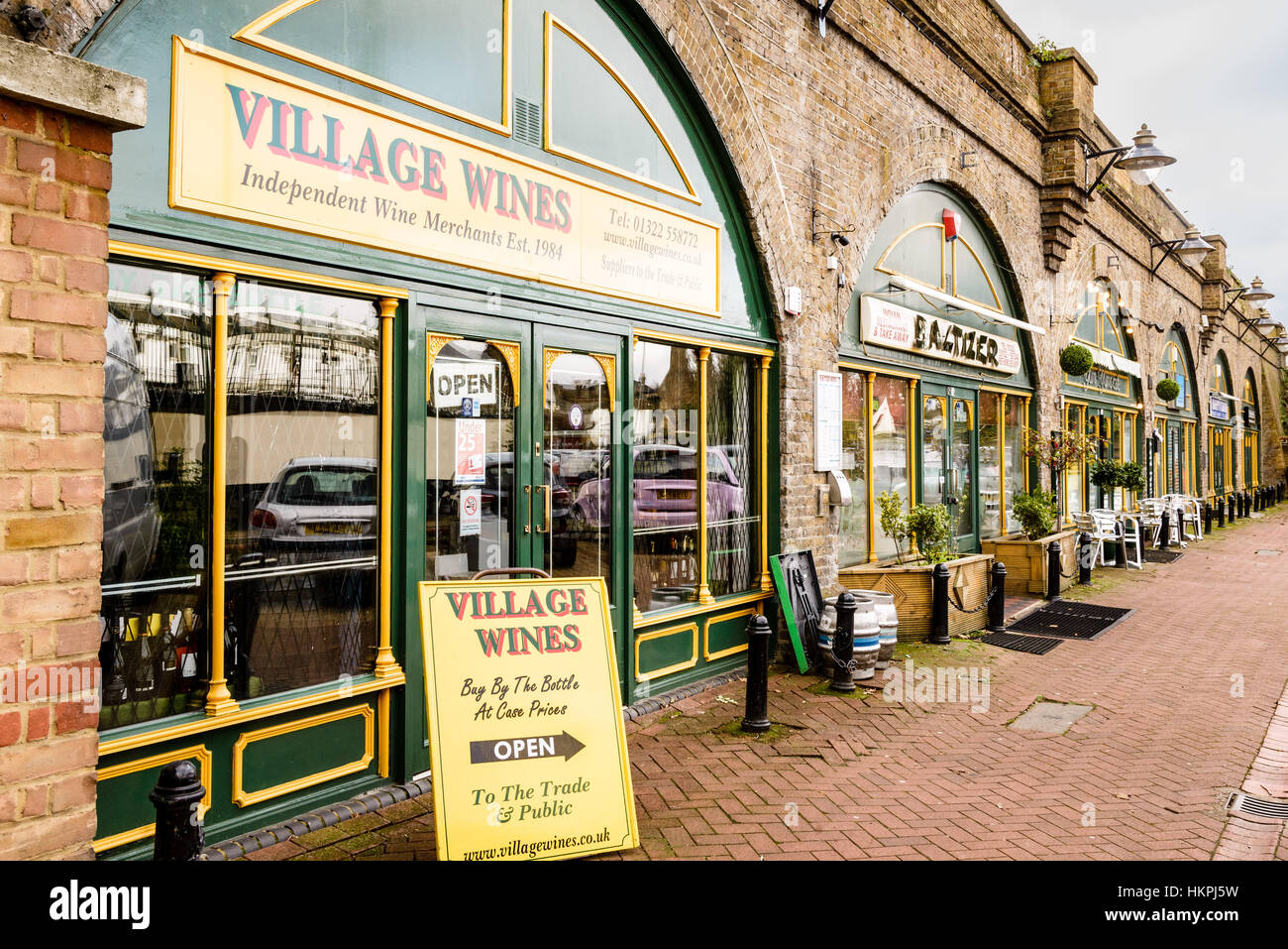 Shops and Cafes occupying space under railway arches, Mill Row, Bexley, Kent Stock Photo