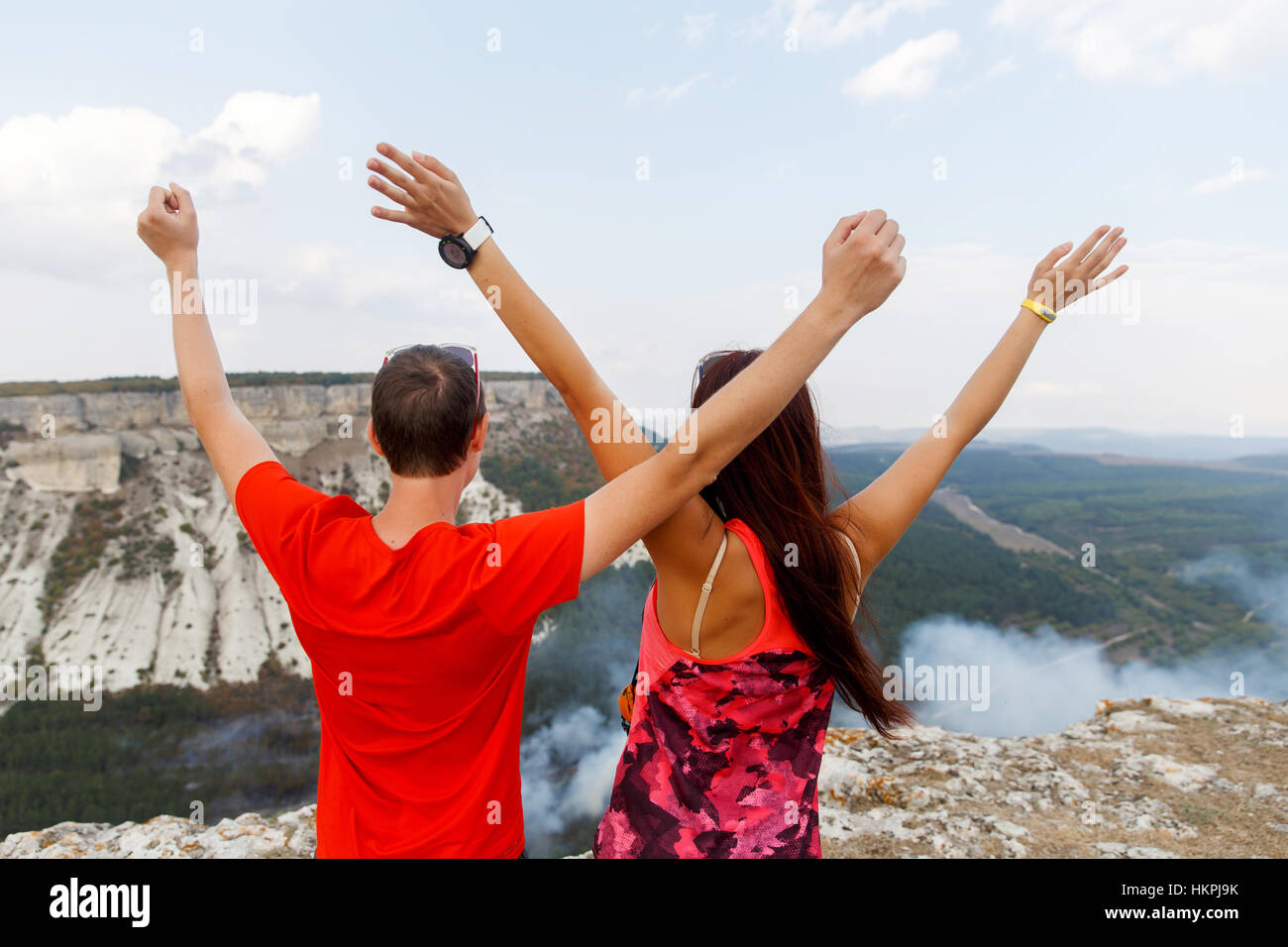 Happy young people among mountains Stock Photo - Alamy