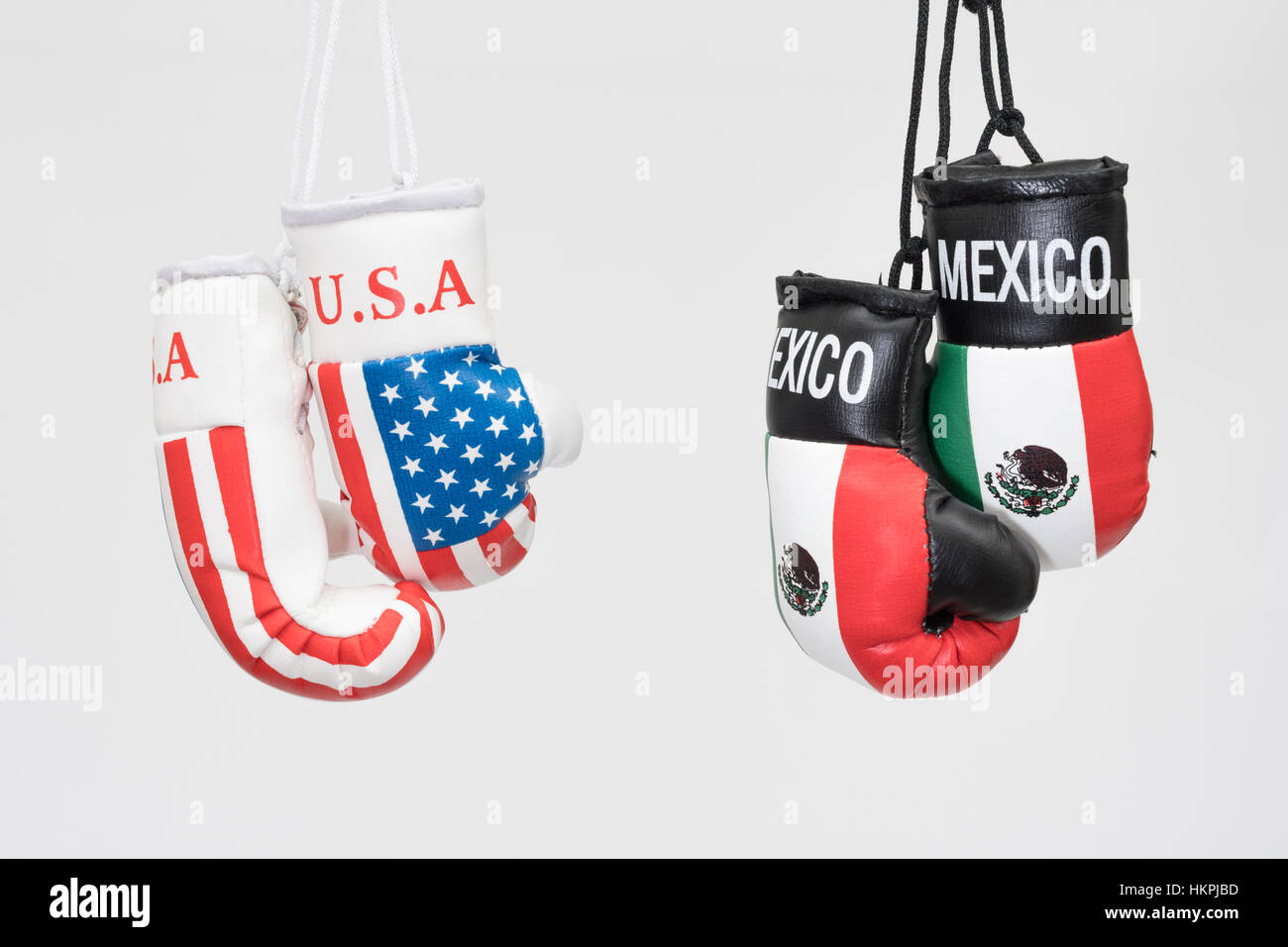 America-Mexico stand-off (Donald Trump) represented by hanging USA and  Mexican emblem boxing gloves. NAFTA breakdown concept Stock Photo - Alamy