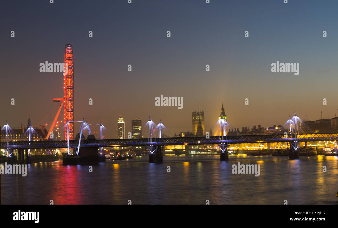 Colorful Night image London showing London Eye,  Bigben and a reelections of colors in the water of river Thames Stock Photo