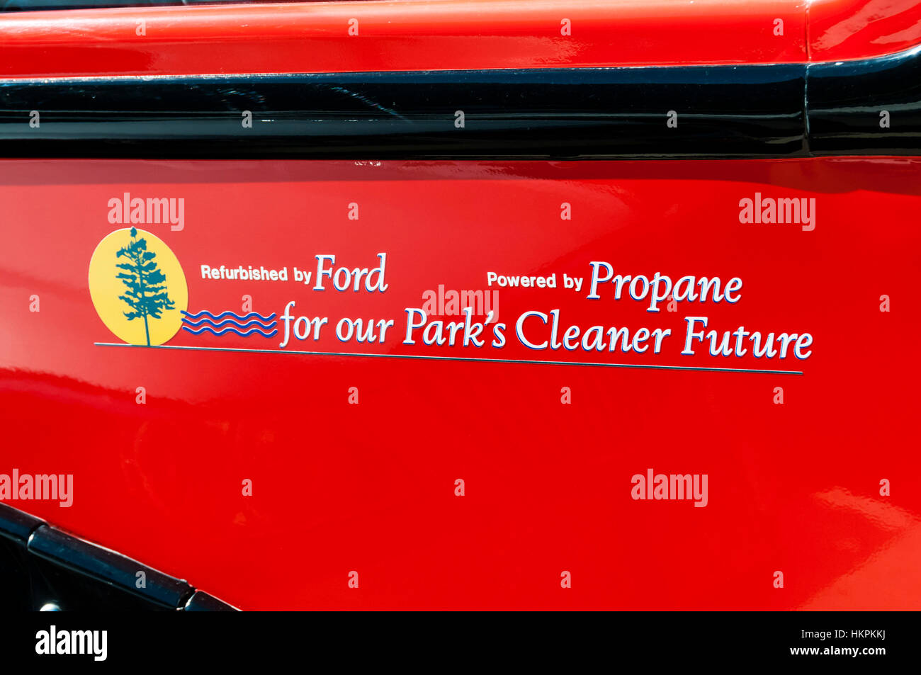 Sign on side of one of Glacier National Parks famous red tour buses.  Propane powered to help preserve air quality. Stock Photo