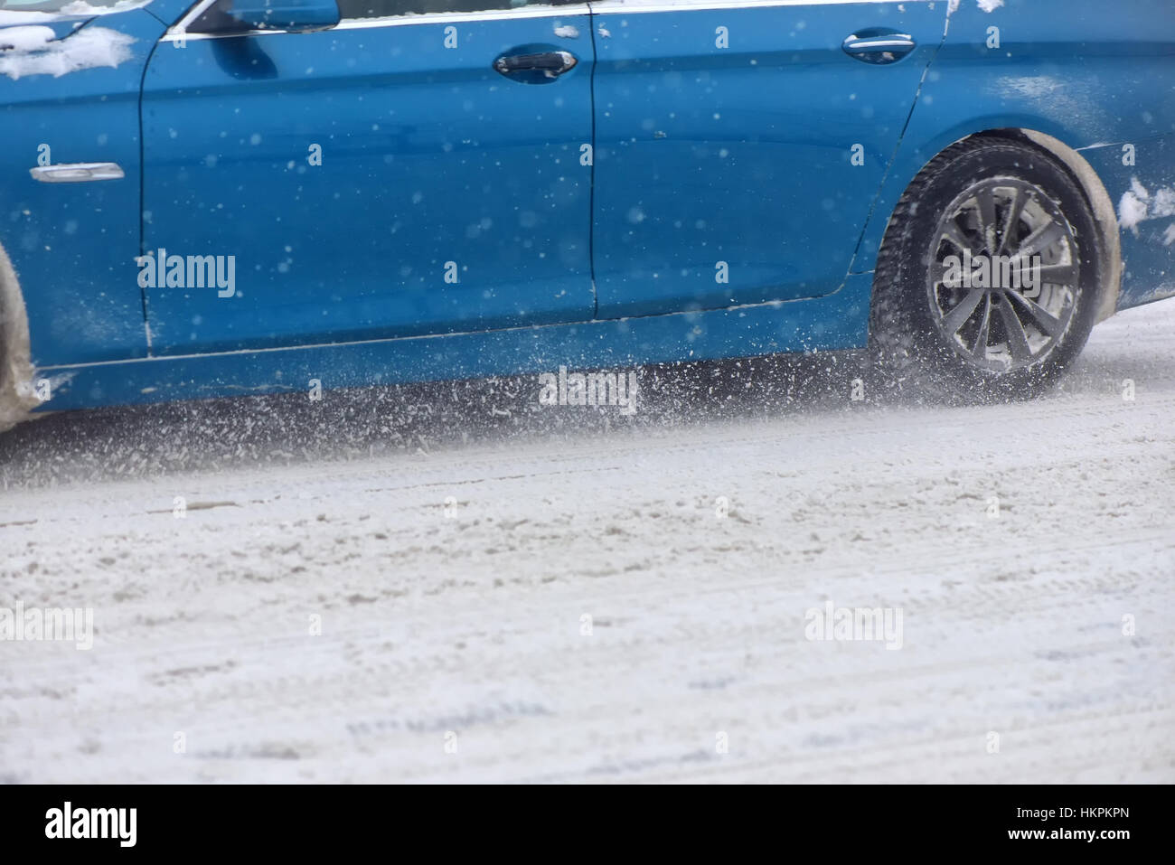 Car with winter tires on snow covered road in a snowy day Stock Photo ...