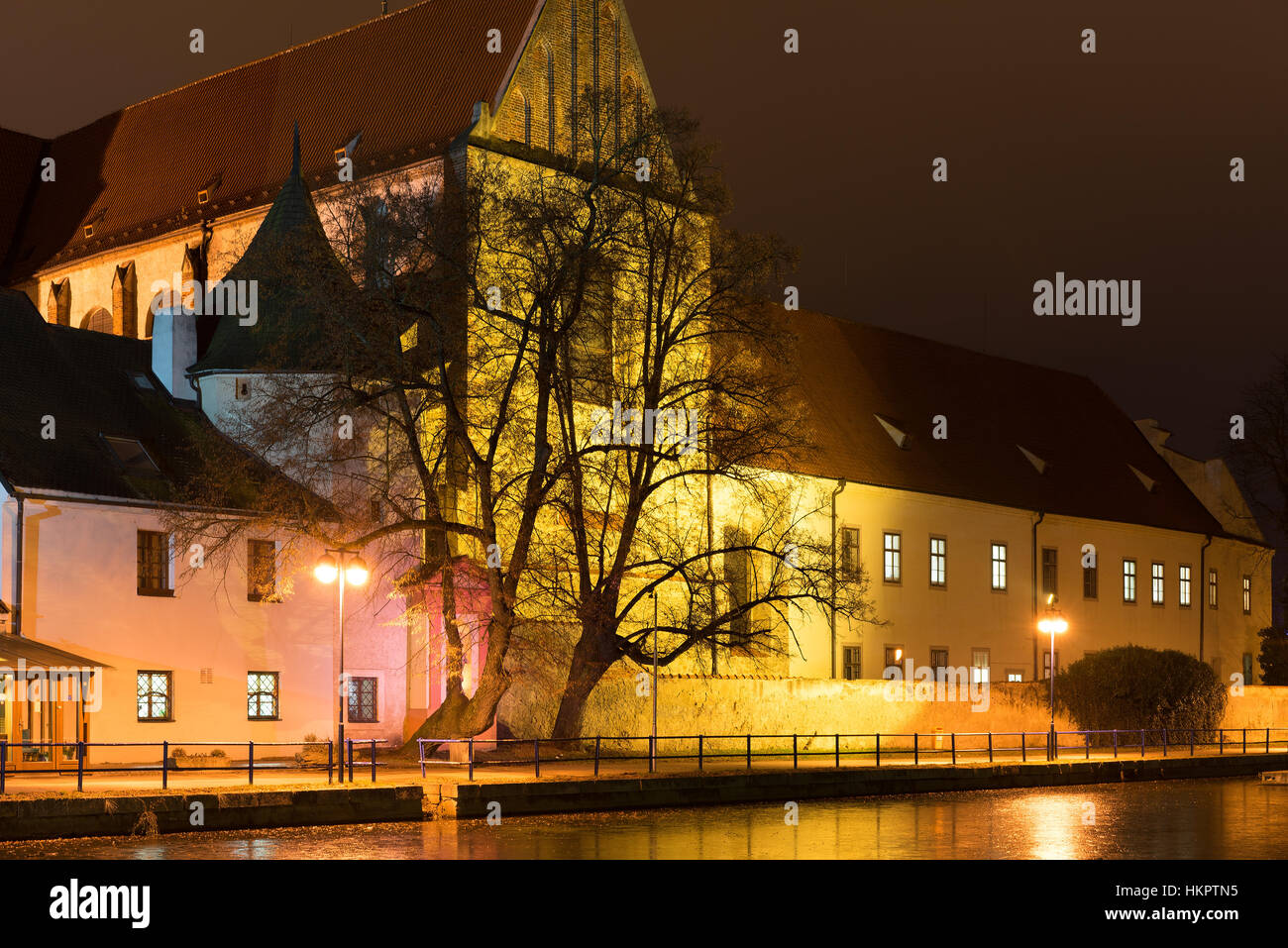 Night architecture in the city. Old church on the bank of river. České Budějovice. Stock Photo