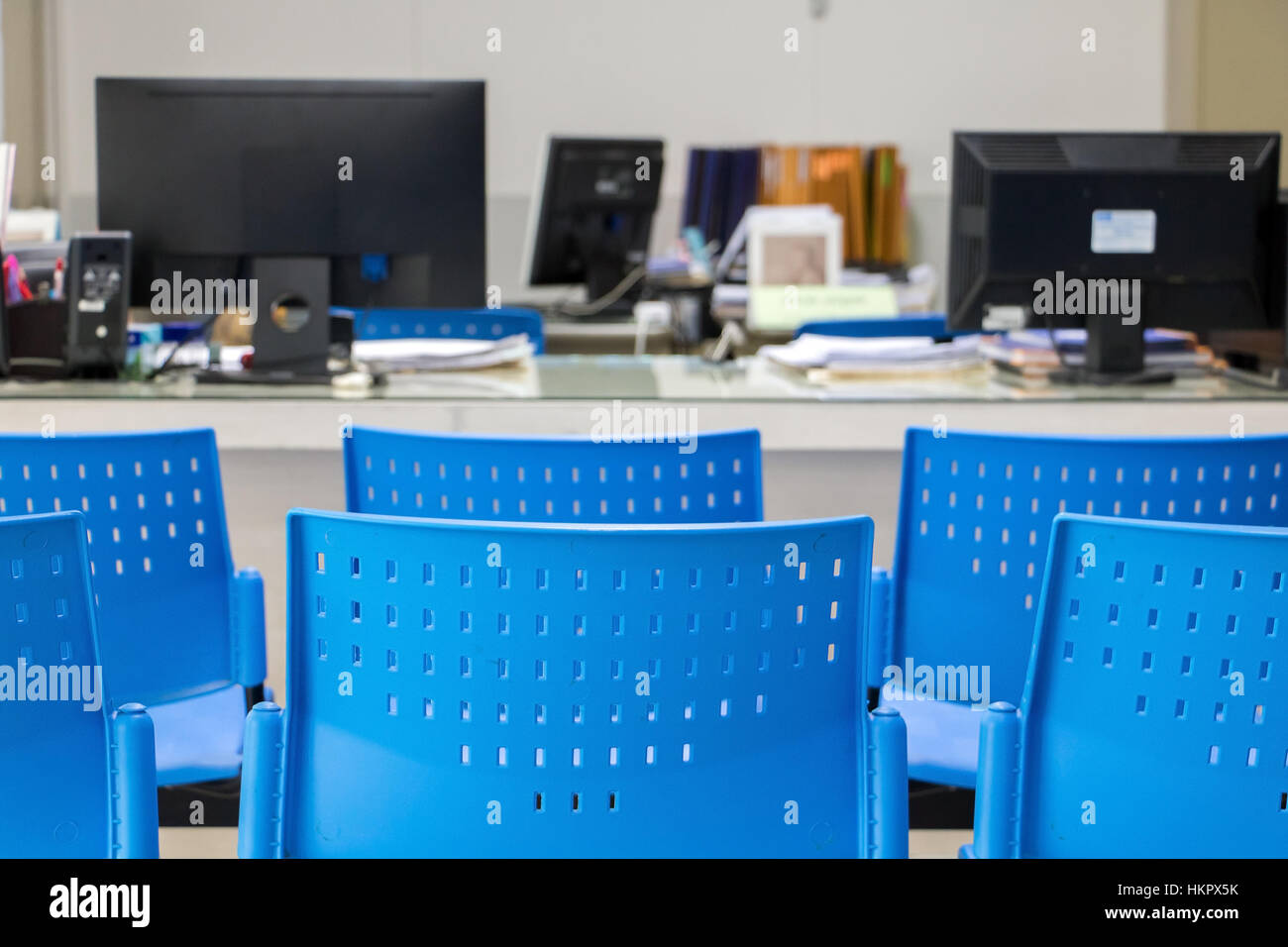 The empty chair before a desk with a computer in the office. Stock Photo