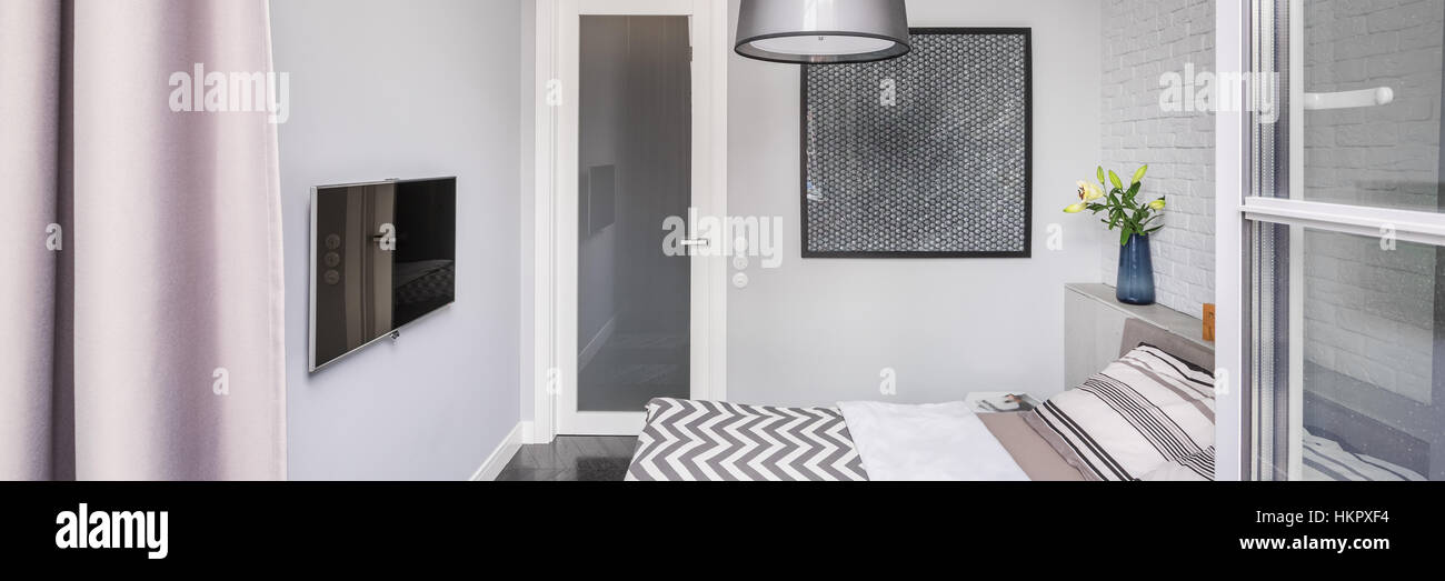 Light bedroom with tv, double bed and open window Stock Photo Alamy