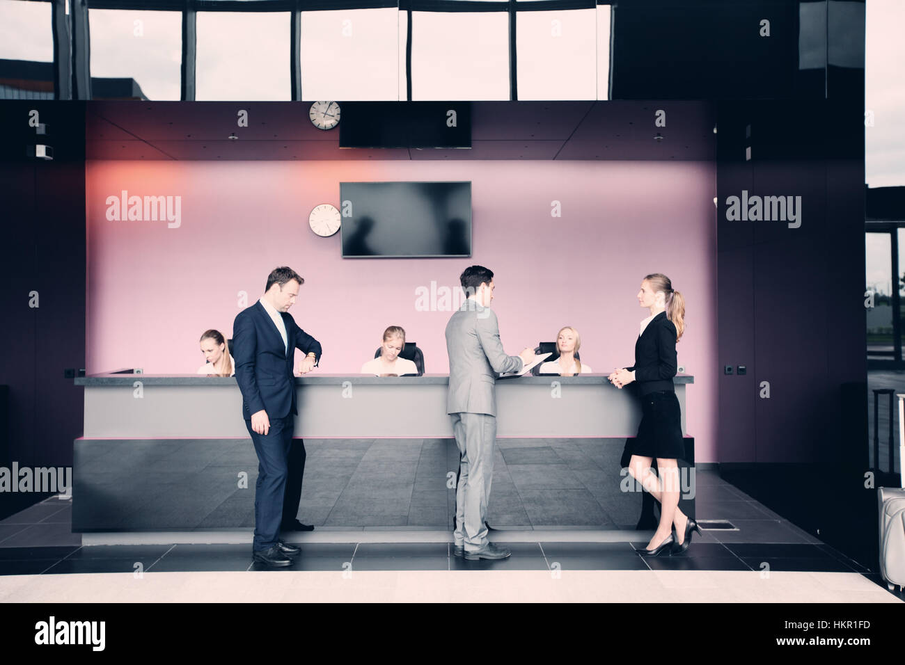 Business People At Front Desk Reception Of Hotel Or Airport Stock