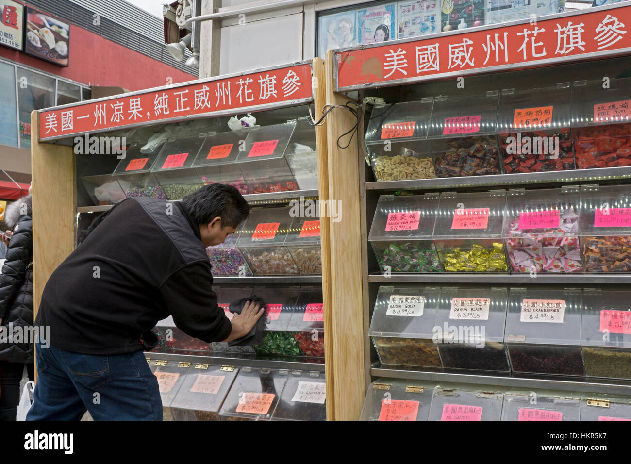 An Unidentified Chinese Man Cleaning An Out Door Food Stand On