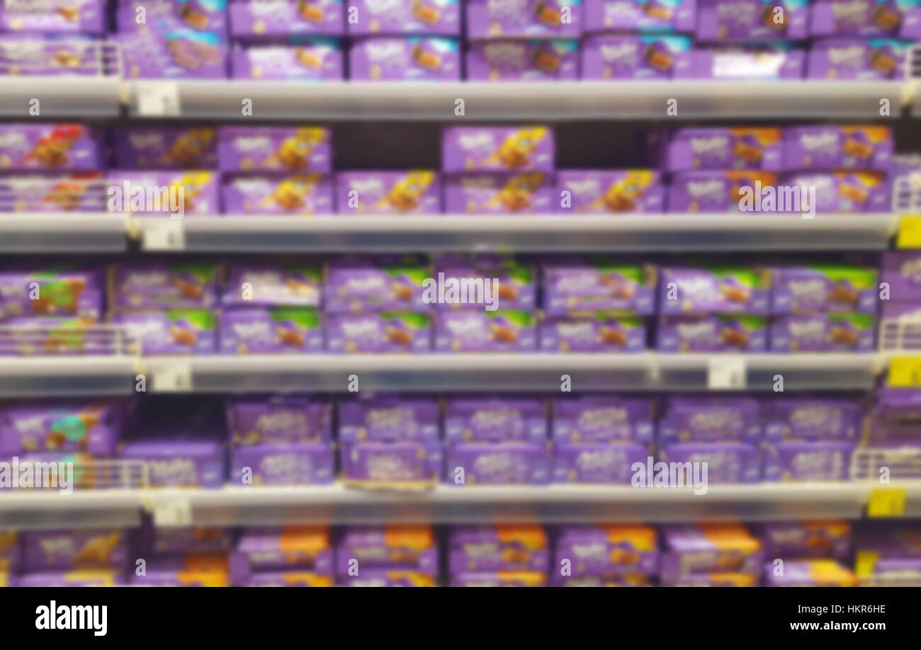 chocolate shelf in supermarket, blurred photo Stock Photo