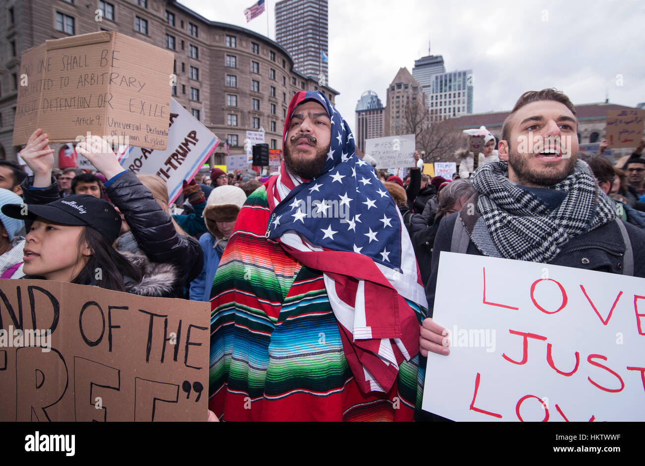 Boston, Massachusetts, USA. 29th January, 2017.  More than 20,000 demonstrators filled Copley Square in central Boston protesting President Donald Trump’s executive order stopped immigration from Iran, Iraq, Yemen, Somalia, Sudan, Libya and Syria to the United States.  Photo shows Izzy a 39 year-old American Citizen of Port Rican and Mexican decent wearing and American flag and a Mexican serape.   The demonstration in Copley Square was organized by the Massachusetts branch of the Council on American-Islamic Relations, CAIR.  Credit: Chuck Nacke/Alamy Live News Stock Photo