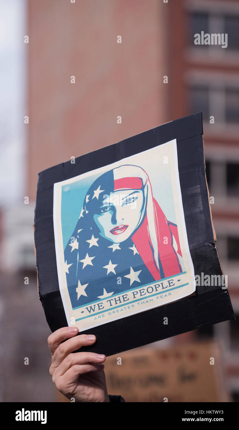 Boston, Massachusetts, USA. 29th January, 2017.  More than 20,000 demonstrators filled Copley Square in central Boston protesting President Donald Trump’s executive order stopped immigration from Iran, Iraq, Yemen, Somalia, Sudan, Libya and Syria to the United States.  Photo shows a hand holding a small protest sign supporting Immigrants.   The demonstration in Copley Square was organized by the Massachusetts branch of the Council on American-Islamic Relations, CAIR.  Credit: Chuck Nacke/Alamy Live News Stock Photo