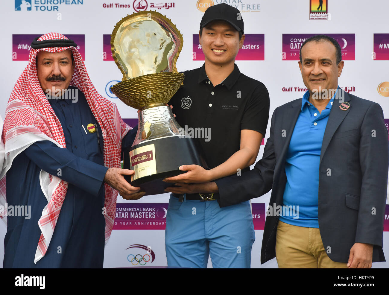 Doha, Qatar. 29th Jan, 2017. Wang Jeunghun (C) of South Korea receives his winners trophy from the President of the Qatar Golf Association Hassan Al Naimi (L) and the CEO of Commercial Bank Joseph Abraham following his victory in the playoff after the final round of the Qatar Masters golf tournament at the Doha Golf Club in Doha, capital of Qatar, Jan. 29, 2017. Wang Jeunghun claimed the title. Credit: Nikku/Xinhua/Alamy Live News Stock Photo