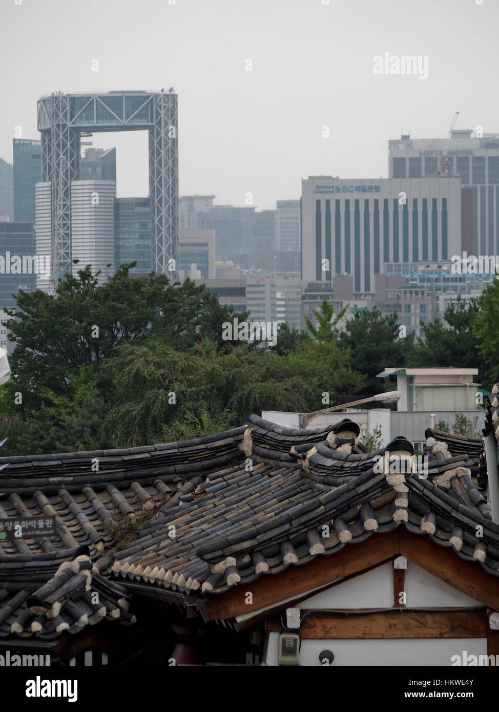 Traditional rooftops of a hanok village in downtown Seoul contrasts ...