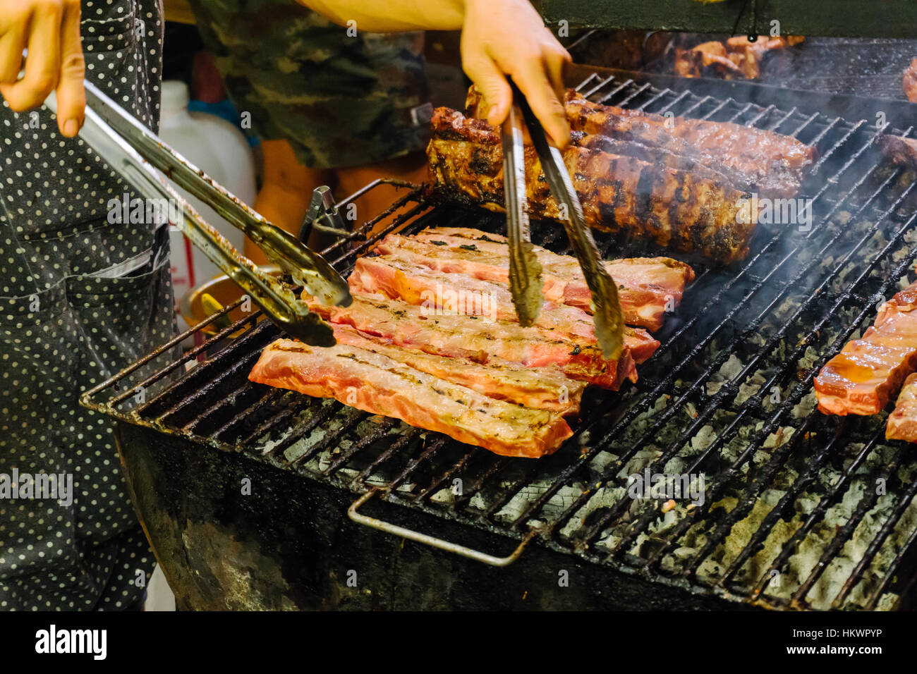 Grilled meat on the barbecue rack outdoor food items set. Street food BBQ grill tools. Concept of eating outdoors in the weekend. Stock Photo