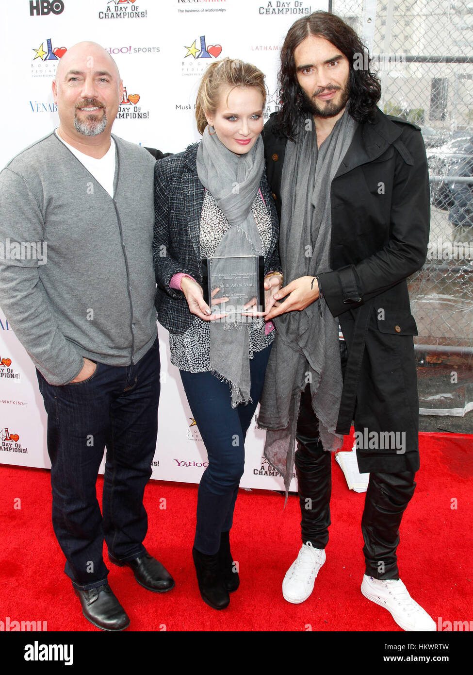 Russell Brand, right, with Adam Venit, left, and Trina Venit, arrive at ...