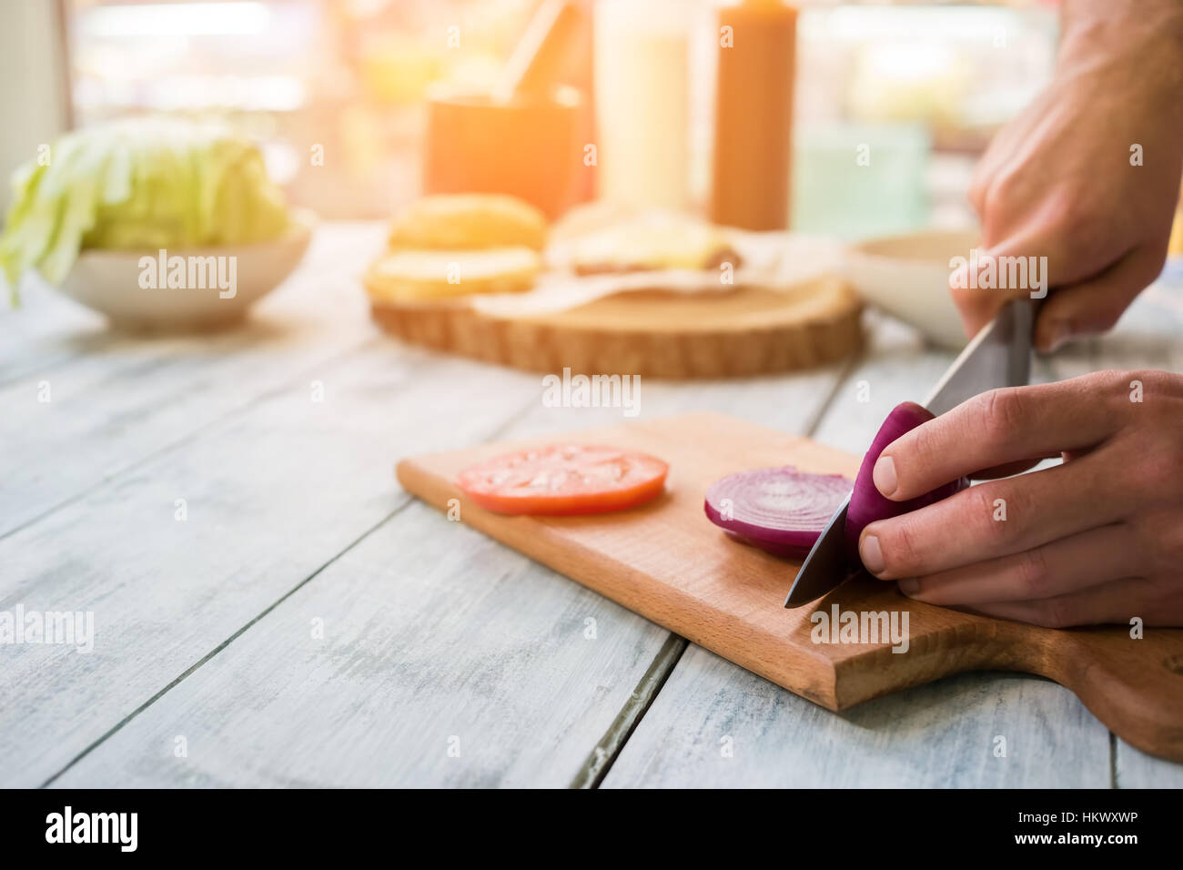 Hands with knife cutting onion Stock Photo - Alamy