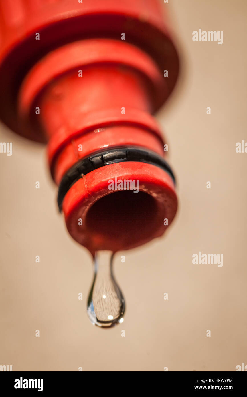 Water dripping from the end of a hose Stock Photo Alamy