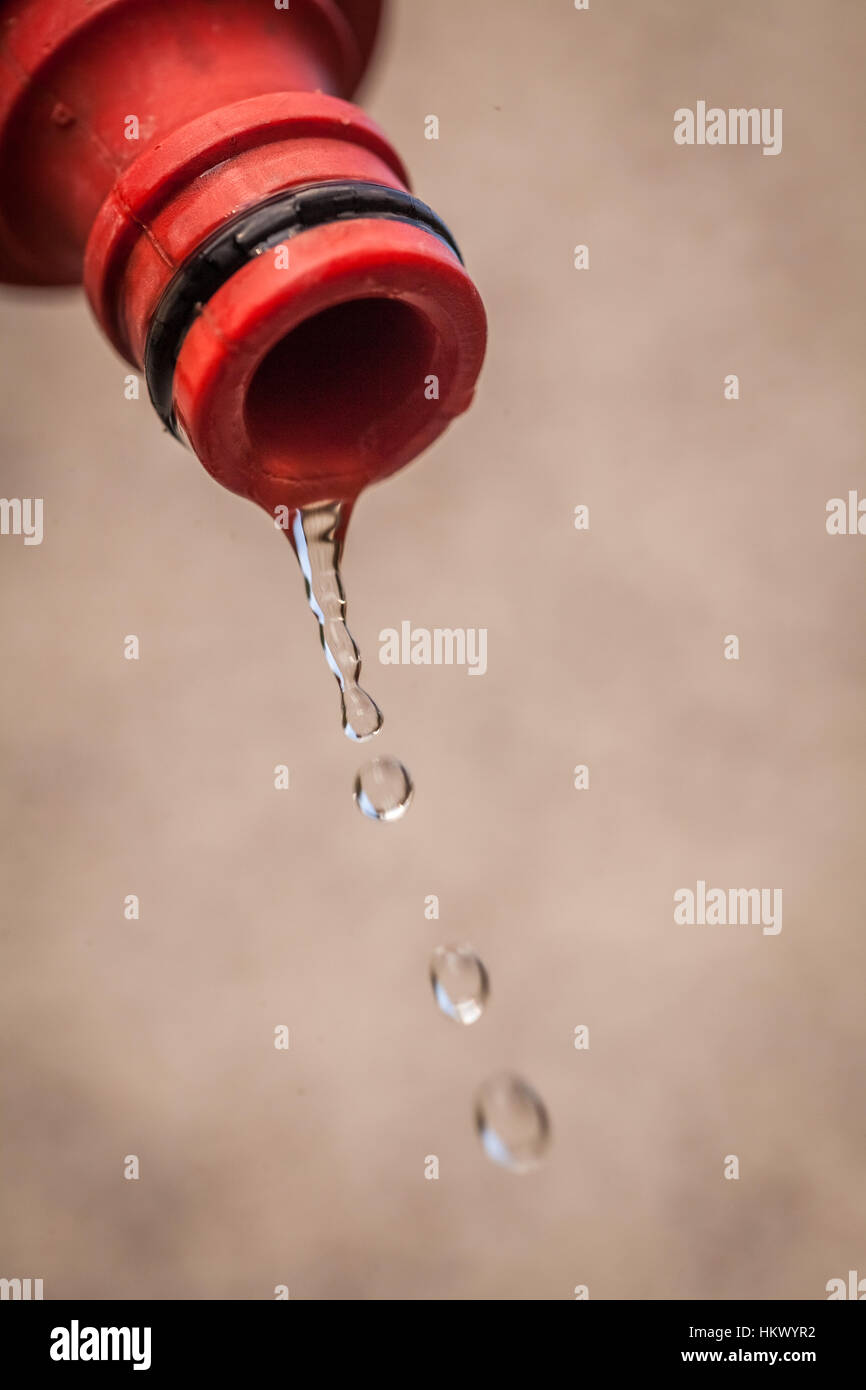 Water dripping from the end of a hose Stock Photo Alamy
