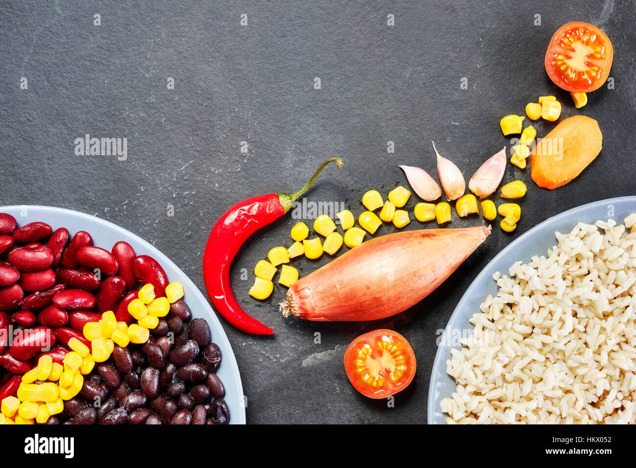 Cooked red and black bean with rice and vegetables, ingredients for chili con carne, space for text. Stock Photo