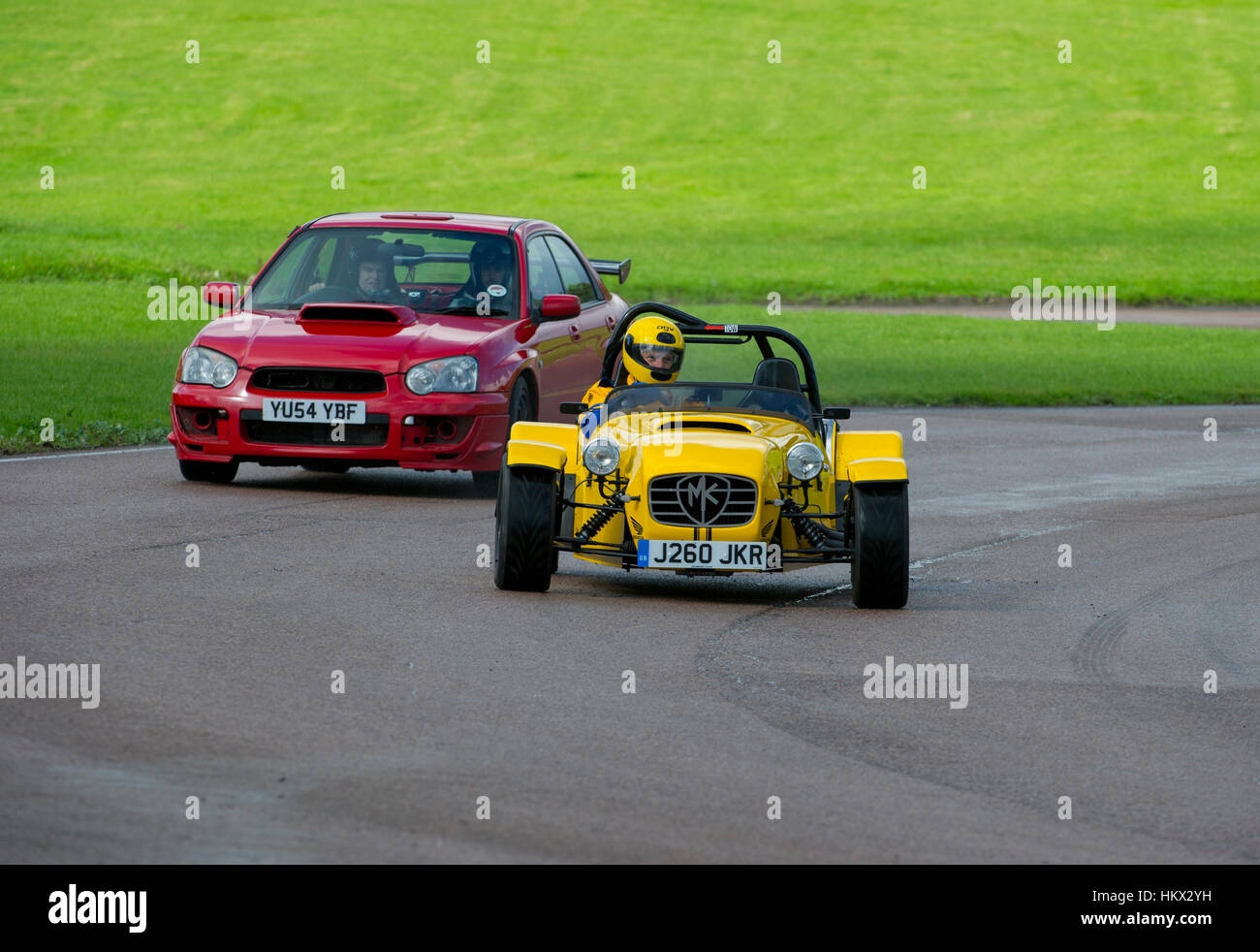 Subaru Impreza chases a Caterham 7 on a track day Lydden Hill race track Stock Photo